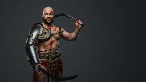 Aggressive gladiator with dual swords isolated on gray Stock Photos