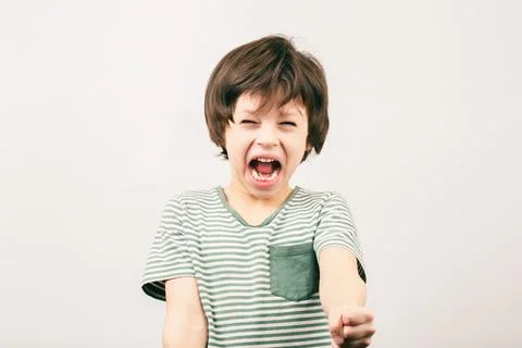Aggressive little boy shouting with risen fist Stock-Fotos