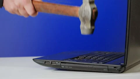 Aggressive man breaking laptop with hammer, Computer failure, error, stress at Stock Footage 225699986