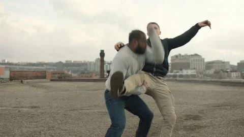 Aggressive man fights and counters a kick from angry man before running away wit Stock Footage 199456174