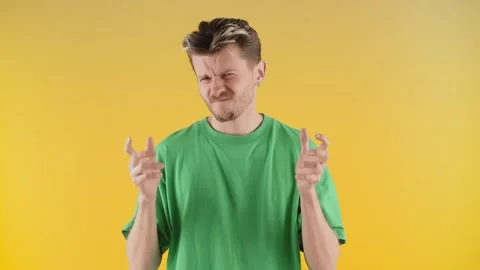 Aggressive man shaking his hands and yelling at the camera. An angry man in a Stock Footage 241780871
