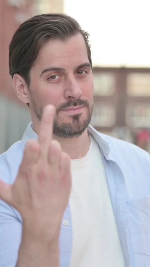 Aggressive Man showing Middle Finger while Standing Outdoor, Vertical Video Video stock 339665412