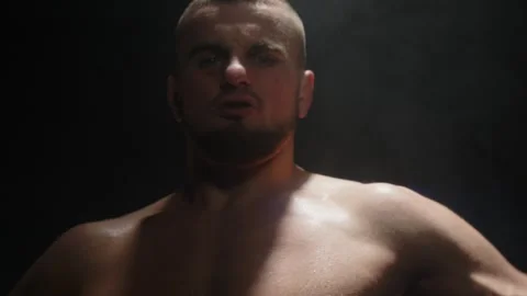 Aggressive mma fighter flexing his muscles and yelling at the camera. Stock Footage 274481783