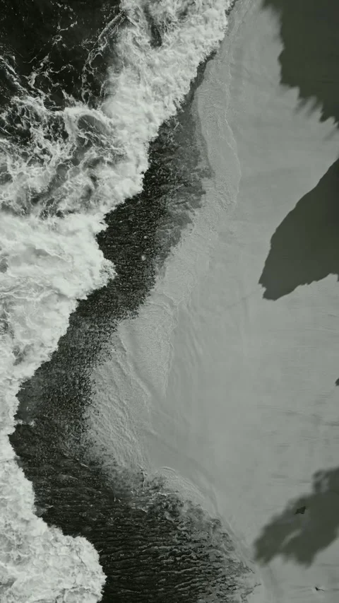 Aggressive ocean breakers collide with steep rocky landscape below Stock-Footage 336977117