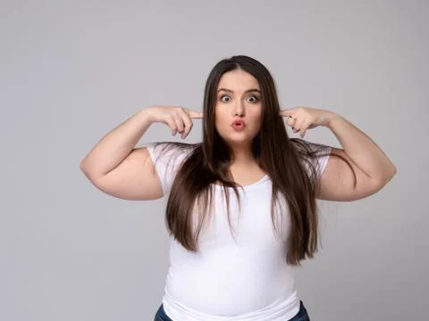 Aggressive Plus Size Model covers ears with fingers. Stock Photos