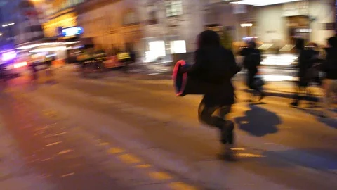 Aggressive protesters running after cops Stock Footage 105347518