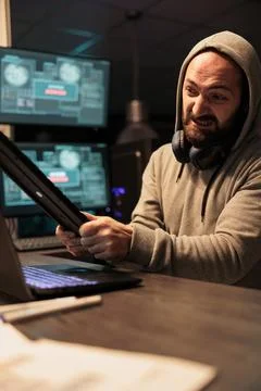 Aggressive violent hacker throwing keyboard 库存照片