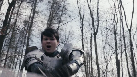 Aggressive violent Medieval knight in armour attacks foe with sword POV Stock Footage 306642843
