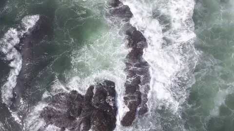 Aggressive waves crashing into ocean rock formations Video stock 70591816