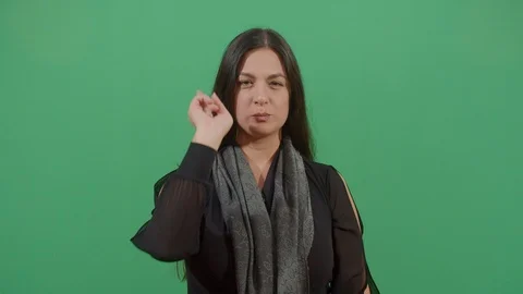 Aggressive woman executing the viewer with the hand in shape of a gun studio Video stock 117976035