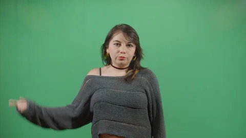 Aggressive woman executing the viewer with the hand in shape of a gun studio Video stock 117977761