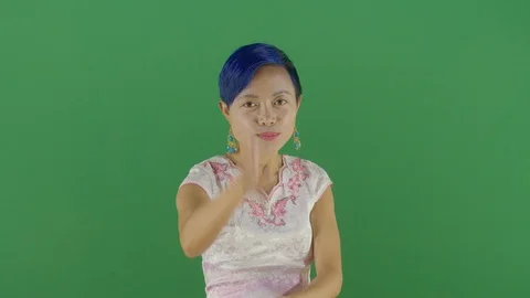 Aggressive woman executing the viewer with the hand in shape of a gun studio Video stock 126308014