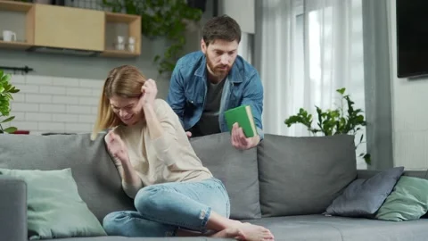Aggressive young bearded man yells at his scared wife swung and threatens  Stock Footage 231227972