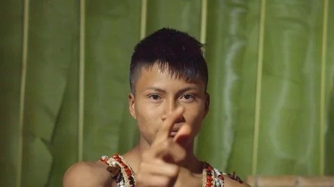 Aggressive young boy executing the viewer with the hand in shape of a gun in Stock Footage 113180785