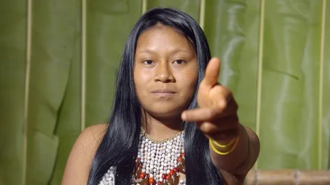 Aggressive young girl executing the viewer with the hand in shape of a gun in Video stock 113181582