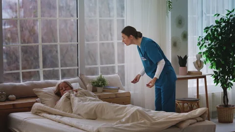 Aggressive young nurse shouting at upset elderly woman patient in hospital Stock Footage 327987170