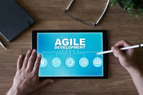 Agile development concept on the device screen. 스톡 사진