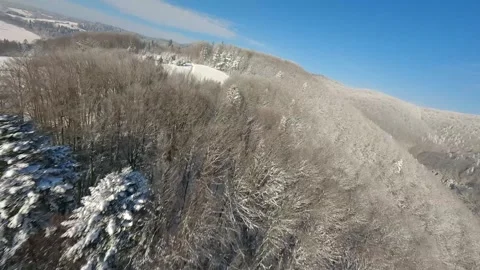 Agile flight over a forest covered with frost on the mountain slopes Stock Footage 301543794