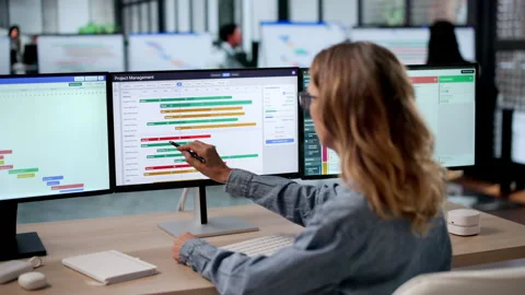 Agile Manager Plans Project Tasks Carefully Using Multiple Computers Video stock 336793303