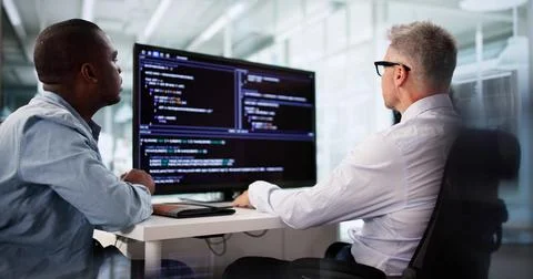 Agile Programmer Testing Software On Desktop In Diverse Team Office. Stock Photos