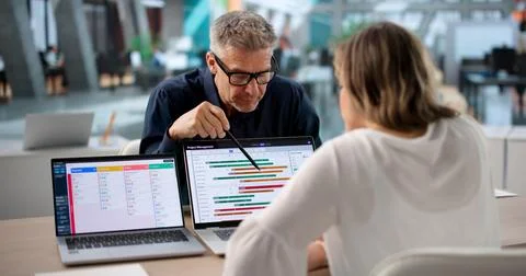 Agile Project Manager And Team Member Review Task Board Together Efficiently. Stock Photos