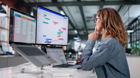 Agile Project Manager Reviews Task Schedule On Laptop Stock Footage 337227138