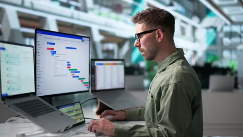 Agile Project Manager Reviews Task Schedule Using Laptop Stock-Footage 340996916