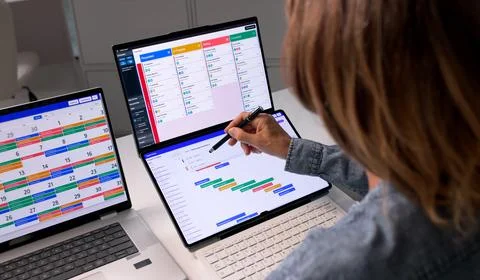 Agile Project Manager Updates Task List On Laptop Using Online Calendar. Stock Photos