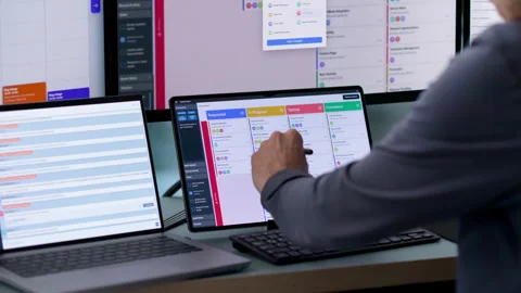 Agile Project Manager Updating Scrum Board While Using Laptop Stockbeeldmateriaal 342963603