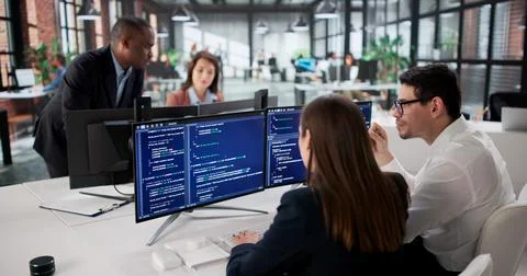 Agile Team Coding New Software On Office Computer- Diverse Professionals. Stock Photos