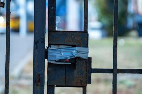 Aging access control device, encased in armored tape, stands guard on a metal Stock Photos