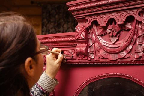 Aging cupboard made of wood with thin brush with hand carved ornaments of bright Stock Photos