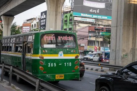 Aging Local Bus Under Elevated Transit Line in Bangkok Stock Photos