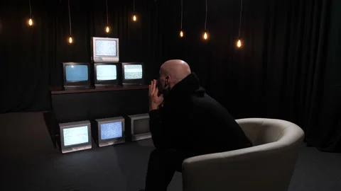 An agitated man looks at the static noise on the screens of many televisions. Stock Footage 219236013