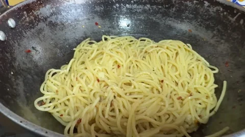 Aglio olio in spaghetti made with olive oil , garlic ,chilli flakes and sea.. Stock Footage 326475734