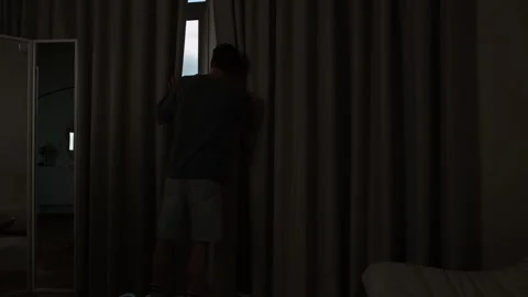 Agoraphobic man staring out the window, afraid to leave home. Mental health Stock Footage 312277523