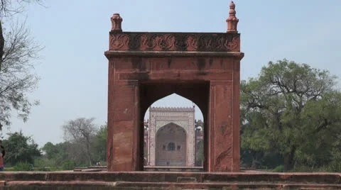 Agra Akbar's tomb gate with a couple  Stock Footage 24656906