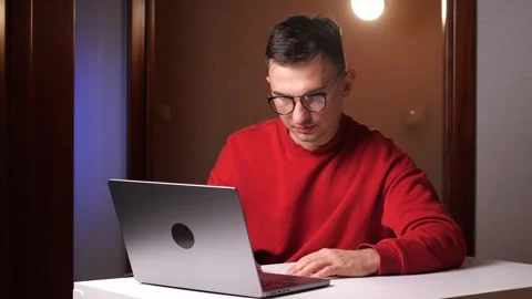 Agree gesture Young programmer freelancer man works on laptop and nodding. Stock Footage 263596663