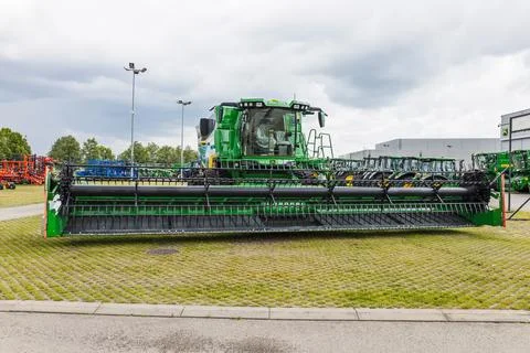 Agricultural combine with massive cutting header. Kaunas, Lithuania, 19 June Stock Photos