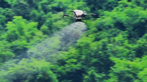 Agricultural Drone Spraying Fertilizer Over Green Hills in Rural Hubei Stock Footage 340050341