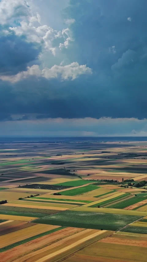 Agricultural farmland under dramatic dark storm clouds Stock Footage 346654307