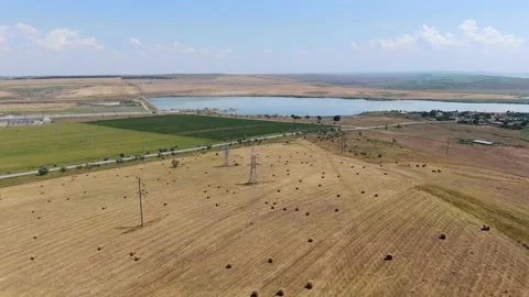 Agricultural fields from a bird's eye view, harvesting wheat with harvesters Stock Footage 159474803