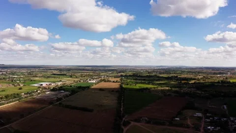 Agricultural Fields Forming Rural Patchwork Landscape Under Blue Sky, Aerial Video stock 334649375