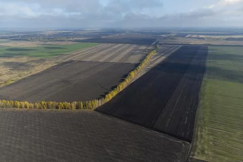 Agricultural fields plowed view from a height, drone's point Stock Photos