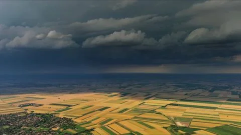 Agricultural fields under dramatic dark storm clouds Stock Photos