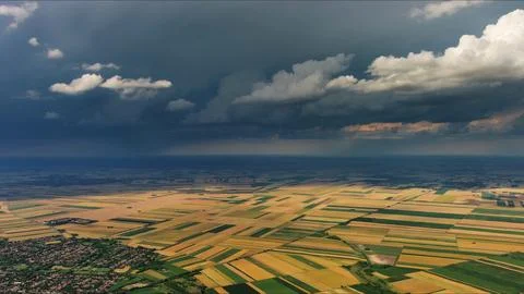 Agricultural fields under dramatic dark storm clouds Stock Photos