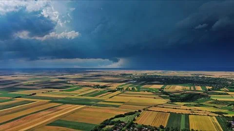 Agricultural fields under dramatic dark storm clouds Stock Photos