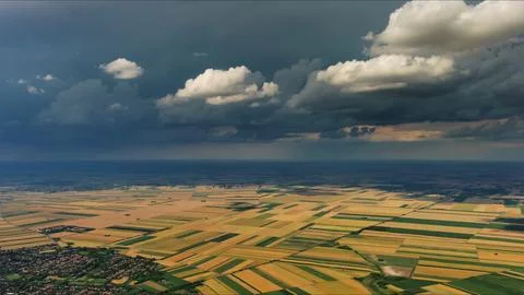 Agricultural fields under dramatic dark storm clouds Stock Photos