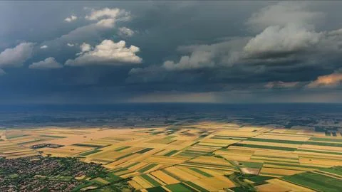 Agricultural fields under dramatic dark storm clouds Stock Photos