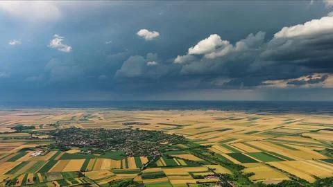 Agricultural fields under dramatic dark storm clouds Stock Photos